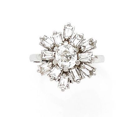 A platinum (850) sunburst ring centered on...