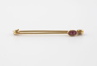 Gold (750) safety pin set with an oval faceted...