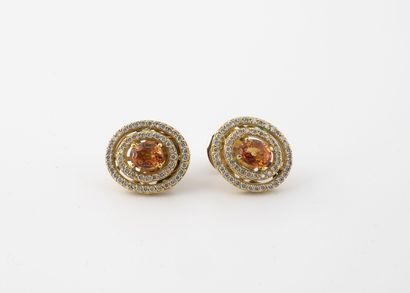 Pair of yellow gold ear studs set with an...
