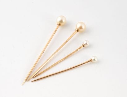 Four yellow gold (750) collar pins set with...