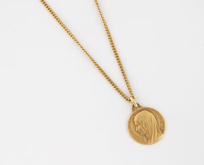 Curb chain and religious medal in yellow...