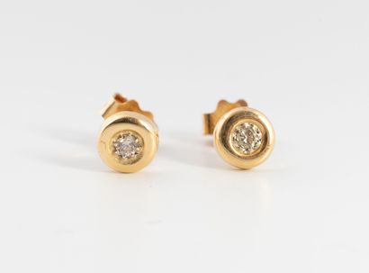 Pair of yellow gold (750) stud earrings centered...