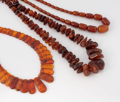 Set of three amber pebble necklaces. 
Length:...
