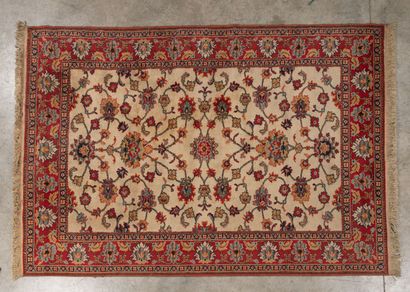 Two polychrome wool rugs with cream fields,...