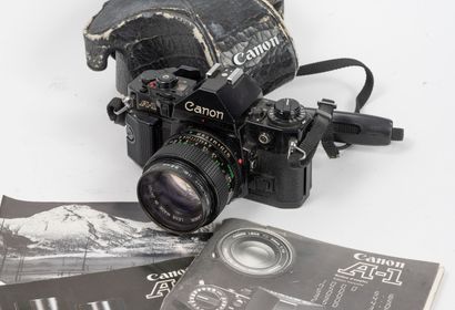 - Black Canon A-1 camera with Canon FD 1.4/50...