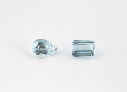 Two faceted blue topazes (treated) on paper.
One...