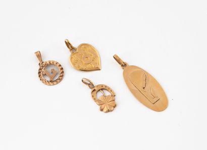 Set of four small pendants in yellow gold...