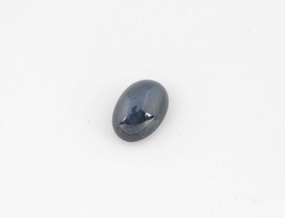 Oval cabochon star sapphire on paper.
Weight:...