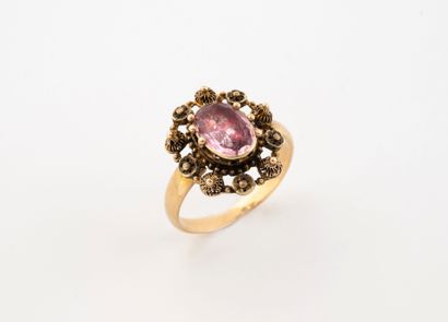 Yellow gold (750) ring centered with an oval...