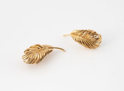 Pair of feather-shaped ear clips in yellow...