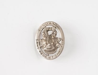 A badge: Commando No. 27. (Local manufac...