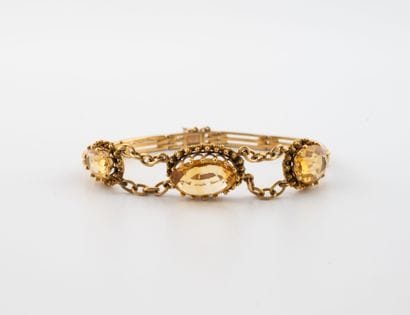 Yellow gold (750) bracelet adorned with three...