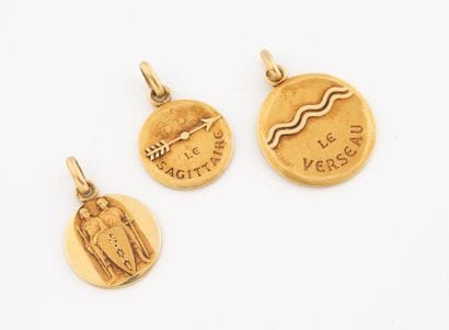 Lot of three round Zodiac medals in yellow...