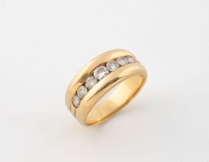 A yellow gold (750) godronnet ring centered...