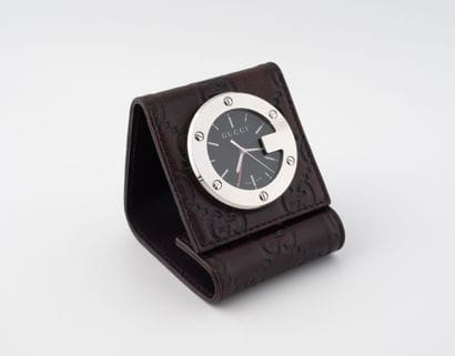 GUCCI
Travel alarm clock in steel and brown...