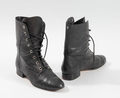 CHANEL
Pair of black leather lace-up boots....