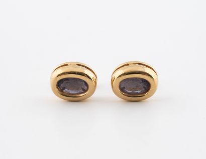 Pair of oval stud earrings in yellow gold...