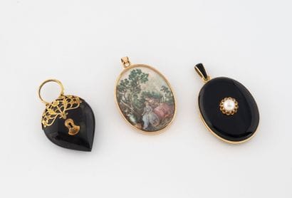 Three pendants : 
- an oval photo holder...