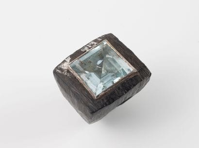 Fancy ring with a large wooden setting adorned...