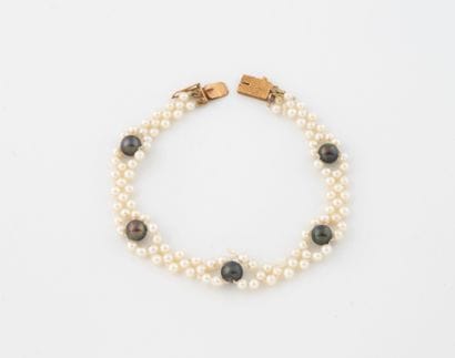 Woven bracelet with white cultured pearls...