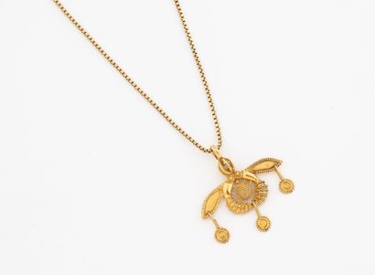Long yellow gold (750) chenille chain holding...