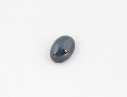 Oval cabochon star sapphire on paper.
Weight:...