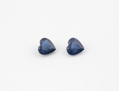 Two heart-cut sapphires on paper.
Total weight:...