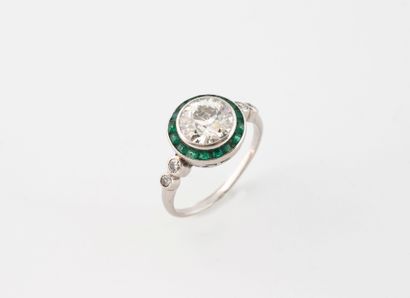 A platinum (850) round-top ring set with...
