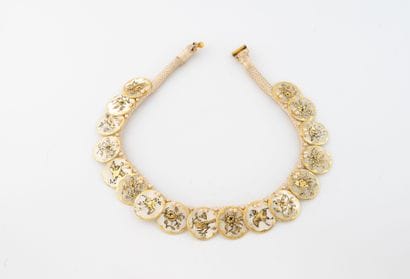 Necklace featuring a cord and round white...