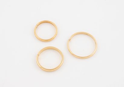 Three yellow gold (750) wedding bands, cut.
Weight:...