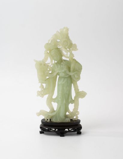 CHINA, 20th century
Guanyin in carved green...
