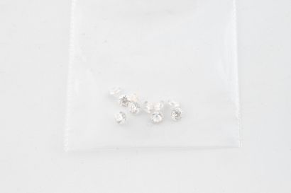 Ten small diamonds on paper.
Total weight:...