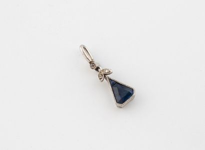 Platinum (850) pendant set with a small sapphire...