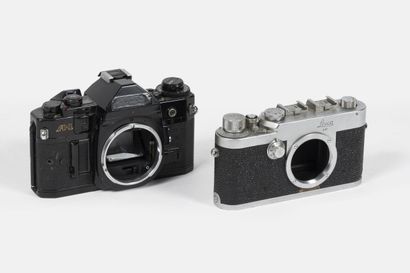 Two cameras, without lenses:
- Leitz Leica...