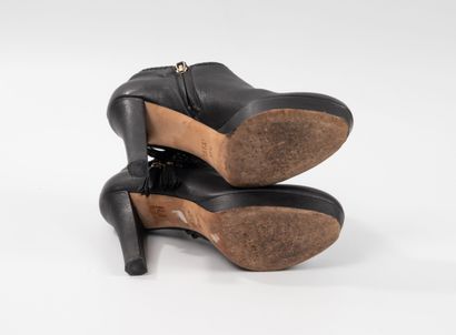GUCCI 
Pair of black leather low boots with...