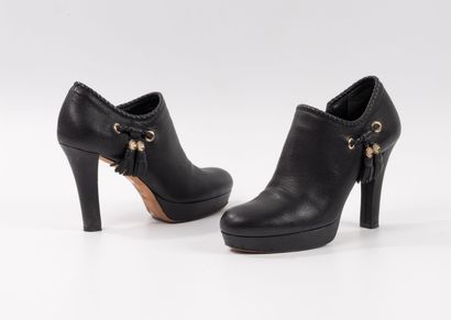 GUCCI 
Pair of black leather low boots with...