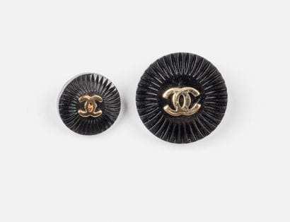 CHANEL, Paris
Two black resin buttons, centered...