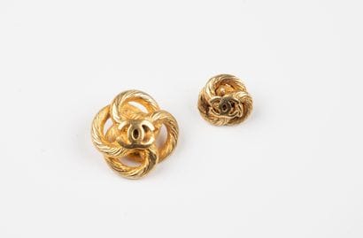 CHANEL, Paris
Two gilded metal buttons forming...