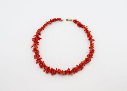 Choker necklace adorned with strands of red...