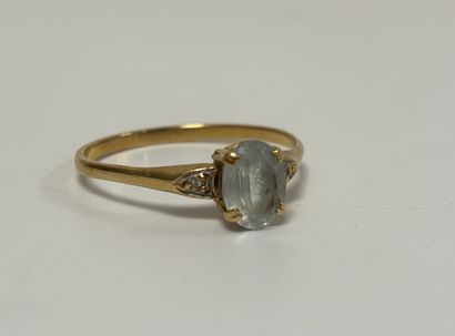 Gilded metal ring set with a blue stone (aquamarine?)...
