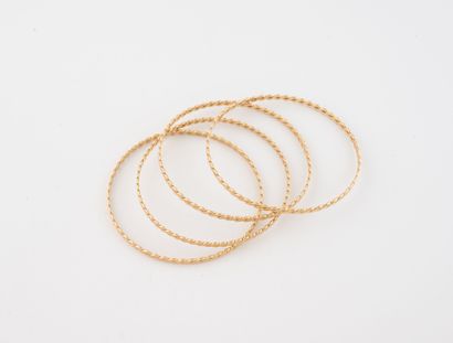 Lot de quatre bracelets jonc en or jaune...