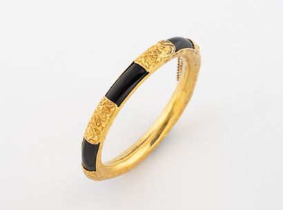 Open-work bangle with bands of black onyx...