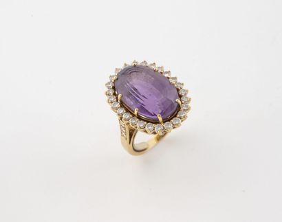 Yellow gold (750) ring centered on a large...