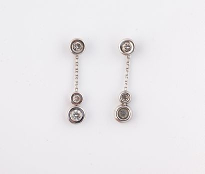 A pair of transformation earrings in white...