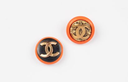 CHANEL, Paris
Two orange resin buttons, one...