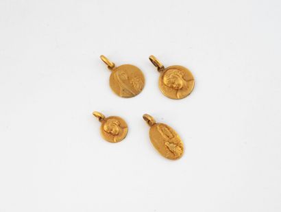 Lot of four religious medals in yellow gold...