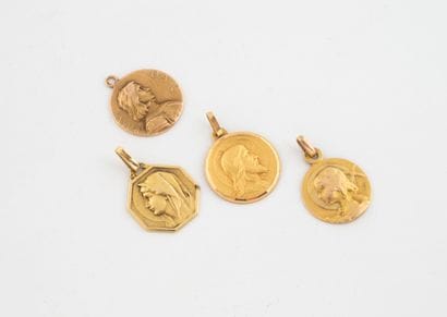 Lot of four religious medals in yellow gold...