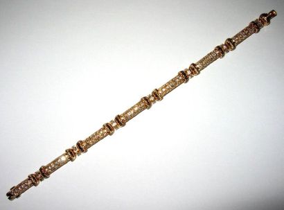Bracelet articulé en or jaune formé de sept...