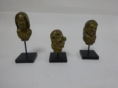 Trois pommeaux de canne en bronze :

- un...