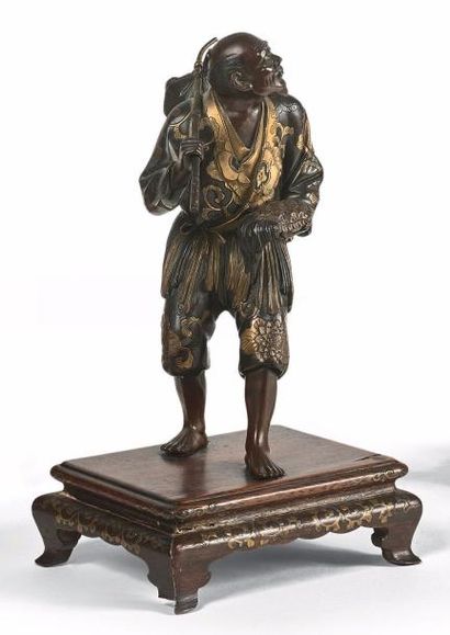 JAPON
Homme portant une tortue et son baluchon.
Statuette...